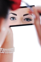 Image showing beautiful young woman applying makeup