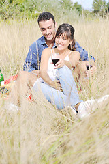 Image showing happy couple enjoying countryside picnic in long grass