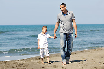 Image showing happy father and son have fun and enjoy time on beach