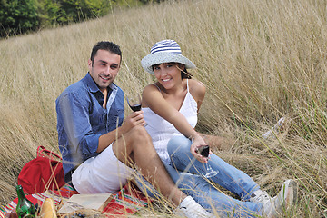 Image showing happy couple enjoying countryside picnic in long grass