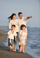 Image showing happy young family have fun on beach at sunset