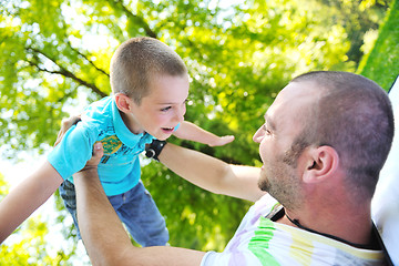 Image showing happy father and son have fun at park