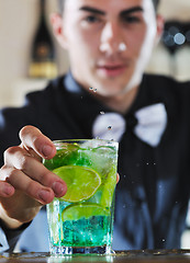 Image showing pro barman prepare coctail drink on party