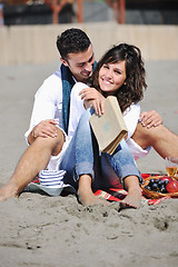 Image showing young couple enjoying  picnic on the beach