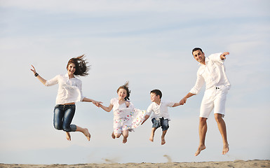 Image showing happy young family have fun on beach