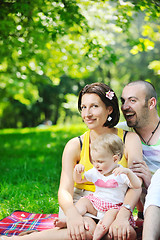 Image showing happy young couple with their children have fun at park