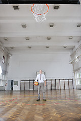 Image showing businessman holding basketball ball