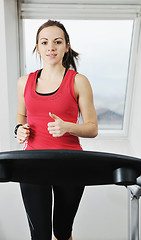 Image showing womanworkout  in fitness club on running track machine 