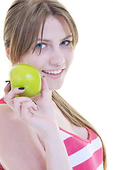 Image showing happy  young  woman eat green apple isolated  on white