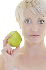 Image showing happy  young  woman eat green apple isolated  on white