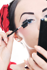 Image showing beautiful young woman applying makeup