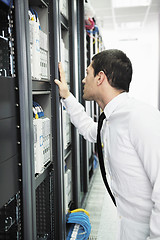 Image showing young it engeneer in datacenter server room