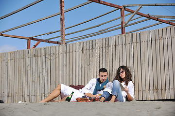 Image showing young couple enjoying  picnic on the beach