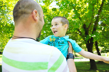 Image showing happy father and son have fun at park