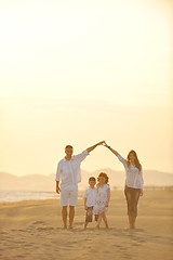 Image showing happy young family have fun on beach at sunset