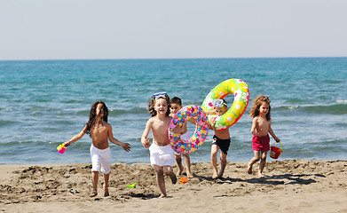 Image showing child group have fun and play with beach toys