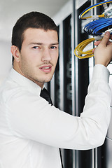 Image showing young it engeneer in datacenter server room