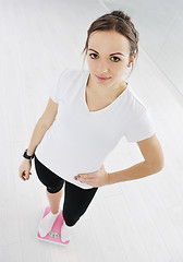 Image showing happy diet concept with young woman on pink scale