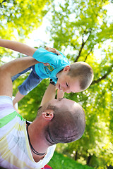 Image showing happy father and son have fun at park