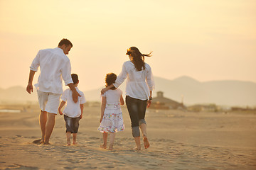 Image showing happy young family have fun on beach at sunset