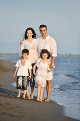 Image showing happy young family have fun on beach at sunset