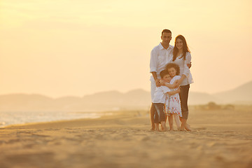 Image showing happy young family have fun on beach at sunset