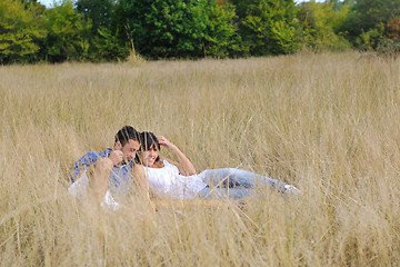 Image showing happy couple enjoying countryside picnic in long grass