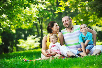 Image showing happy young couple with their children have fun at park