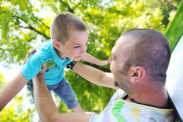 Image showing happy father and son have fun at park