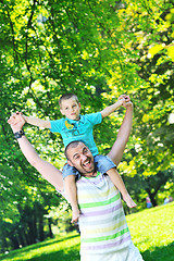 Image showing happy father and son have fun at park