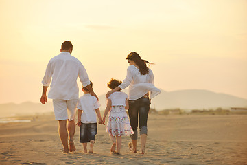 Image showing happy young family have fun on beach at sunset