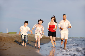 Image showing happy young family have fun on beach