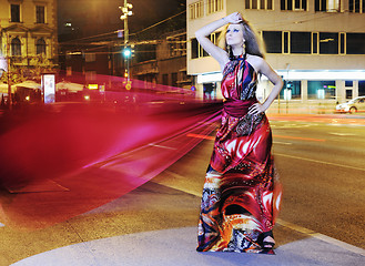 Image showing elegant woman on city street at night