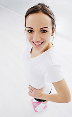 Image showing happy diet concept with young woman on pink scale