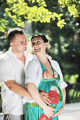 Image showing Happy pregnant couple at beautiful sunny day in park