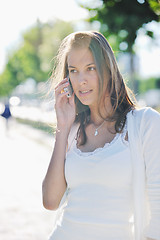 Image showing young woman talk by cellphone on street