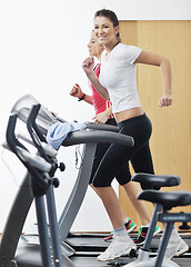 Image showing womanworkout  in fitness club on running track machine 