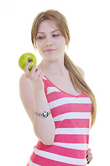 Image showing happy  young  woman eat green apple isolated  on white