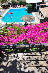 Image showing romantic balcony with flowers and pool view