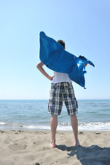 Image showing funny superhero standing on beach