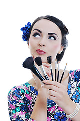 Image showing beautiful young woman applying makeup