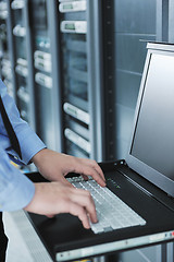 Image showing young it engeneer in datacenter server room