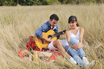 Image showing happy couple enjoying countryside picnic in long grass