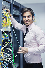 Image showing young it engeneer in datacenter server room