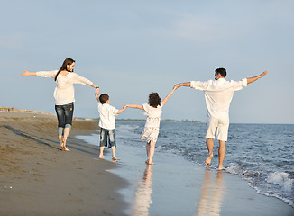 Image showing happy young family have fun on beach at sunset