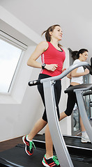 Image showing woman workout  in fitness club on running track 