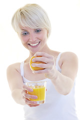 Image showing Young woman squeeze orange juice