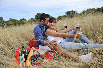 Image showing happy couple enjoying countryside picnic in long grass