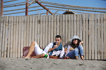 Image showing young couple enjoying  picnic on the beach