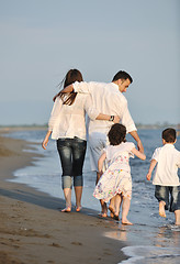 Image showing happy young family have fun on beach at sunset